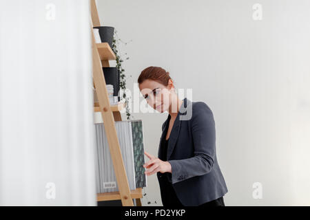 Woman looking for folder in home office Stock Photo