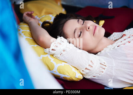 Woman stretched out sleeping Stock Photo