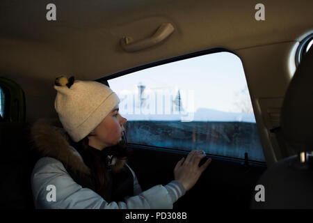 Girl looking out of car window Stock Photo