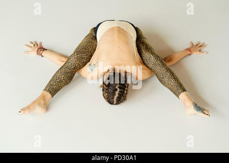 Woman practising yoga on floor Stock Photo