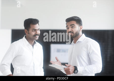 Colleagues talking in office Stock Photo