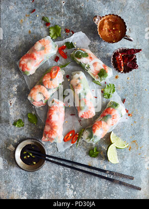 Prawn rolls on rice paper and pair of chopsticks Stock Photo
