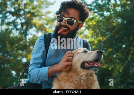 Man and dog having fun, playing, making funny faces while restin Stock Photo