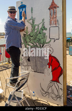 Cartoonist at the Pier Herne Bay as part of the Herne Bay Cartoon Festival Held Annually Stock Photo