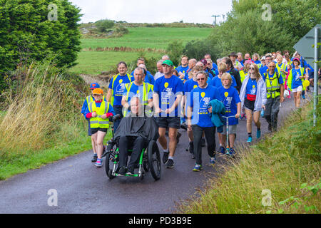 Ballydehob, West Cork, Ireland. 6th August, 2018. Father Tony Coote today completed his epic Walk While You Can walk to raise awareness for the Irish Motor Neurone Disease Association. Father Tony Coote already a sufferer of Motor Neurone Disease started back on 10th July in Letterkenny Donegal and finished today 6th August in Ballydehob West Cork, a total of 545Km. He was joined for the final stage by a huge crowd of fellow walkers and well wishers who accompanied him into Ballydehob. . Credit: aphperspective/Alamy Live News Stock Photo