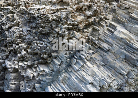 Background texture of the petrified volcanic lava on the coast. Stock Photo