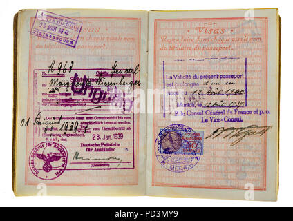 1935's vintage French passport, pages with 1939 German visas stamps marks and renewal date from August 12 1939 until August 12 1940, Stock Photo