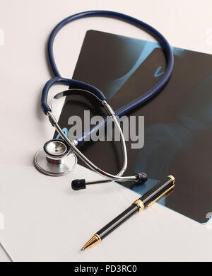 stethoscope,x-ray and pen on the table. Stock Photo