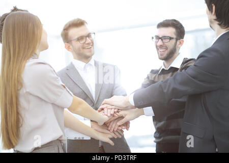 businessman and his business team with hands clasped together to show their unity Stock Photo