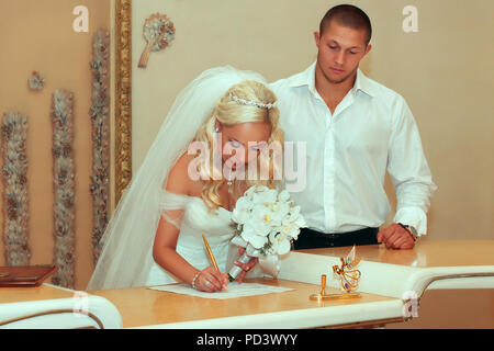 Wedding ceremony. Wedding couple leaving their signatures Stock Photo