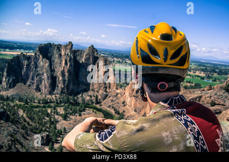 Rock climber looking away at rock formation, Smith Rock State Park, Terrebonne, Oregon, United States Stock Photo