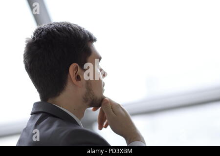 close up.Businessman looking through his office window Stock Photo