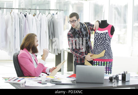 two fashion designers are working on creating women's clothing in the Studio Stock Photo