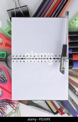 opened Notepad on office supplies on white background Stock Photo