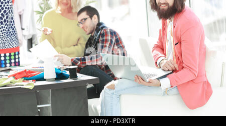 stylish designer and colleagues in the creative workshop Stock Photo