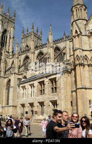 Group of tourists taking a selfie outside York Minster, North Yorkshire, England, UK. Stock Photo