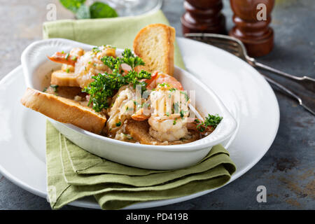 Shrimp and tomato sauce appetizer with toasted bread Stock Photo