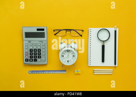 Table top view aerial image of back to school of education season background concept.Flat lay accessories for business finance the clock & calculator  Stock Photo