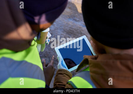 Miners Using Tablet Outdoors Stock Photo