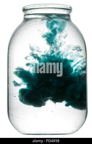 Paint swirling in water. Splash of paint in a glass jar. Stock Photo