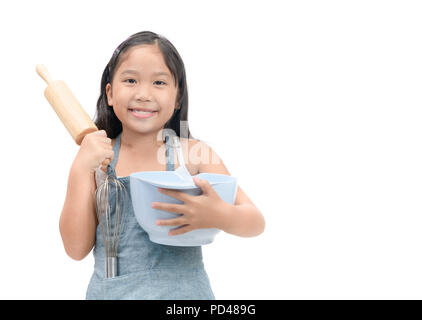 Cute asian girl holding cooking utensils isolated on white background Stock Photo