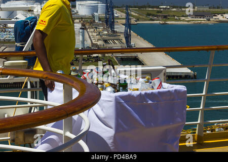 Cape Canaveral, USA - APRIL 29, 2018: The waiter with alcoholic drinks at luxury cruise ship Oasis of the Seas by Royal Caribbean. Stock Photo