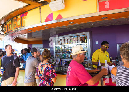 Cape Canaveral, USA - APRIL 29, 2018: The waiter with alcoholic drinks at luxury cruise ship Oasis of the Seas by Royal Caribbean. Stock Photo