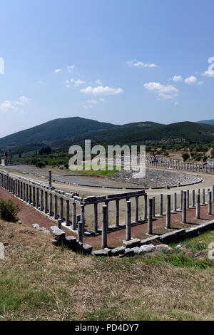 The Gymnasium and Stadium complex at Ancient Messene. Peloponnese. Greece. The horse shoe-shaped end of the Stadium includes 18 tiers of seats with 18 Stock Photo