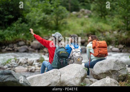 Group of Women Friends Backpacker Enjoy Road Trip Traveling and Taking selfie in the Forest in Weekend Summer - Lifestyle and Recreation Concept. Stock Photo