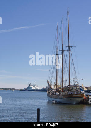 Historic sailing ship with three masts and icebreakers in the harbour of Helsinki Finland on a fine summer day Stock Photo