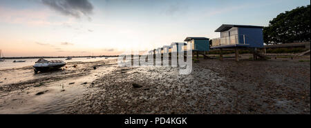 Osea minimalist Beach huts in England modelled on huts in Maldives captured at sunset in summer on secluded beach at low tide Blackwater Estuary Stock Photo