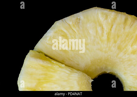 Pieces of juicy ripe pineapple on a black background Pieces of juicy ripe pineapple on a black background Stock Photo