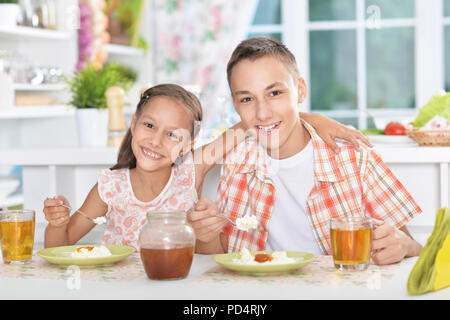 Brother and sister having breakfast Stock Photo