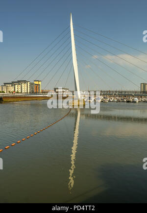 Wide angle view of the Sail Bridge, a footbridge of the River Tawe. It is part of the Swansea SA1 development which incorporates the marina. Stock Photo