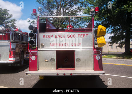 Back of red fire truck with the words Keep Back 500 Feet and Members Only panted in red on the chrome in the back