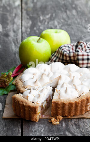 Tasty  meringue pie with rhubarb and apple on wooden table Stock Photo
