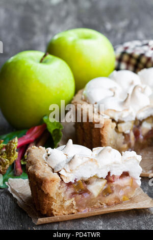 Tasty  meringue pie with rhubarb and apple on wooden table Stock Photo