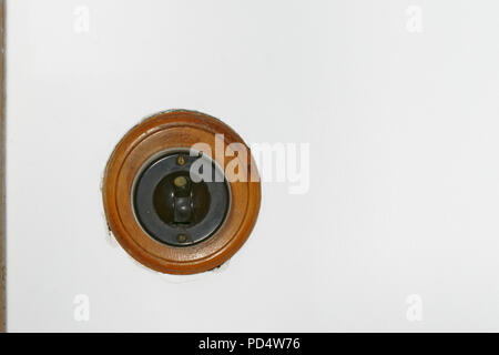 Old fashioned bakelite light switch with a wood surround Stock Photo