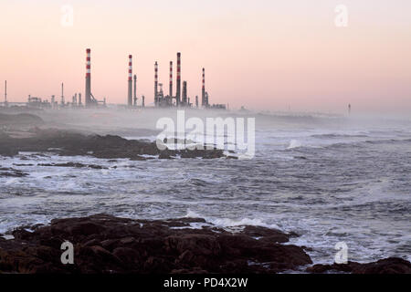 Early morning view of an oil refinery near the sea Stock Photo