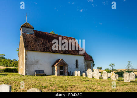 St Mary's Church in Upwaltham - a small 12th century church in Upwaltham surrounded by countryside and blue sky, Upwaltham, West Sussex, England, UK Stock Photo