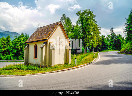 Small chapel set on a inside bend in the road in the alpine region of Austria Stock Photo