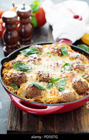 Baked meatballs with spaghetti, tomato sauce, basil and cheese Stock Photo