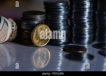 Indian currency coines stacked behind coin of Rupees Five Stock Photo