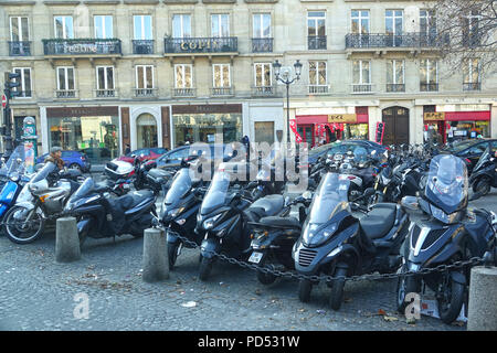Several motorcycles parked on a street in Paris Stock Photo