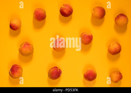 Many juicy beautiful amazing nice peaches on yellow surface. Beautiful food art background. Top view, copy space. Stock Photo