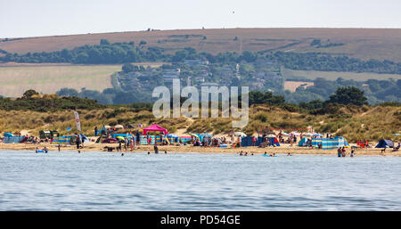People out enjoying the very hot weather, riding the waves, boating and windsurfing.  Resting and playing on the sand, at Shell Bay and Sandbanks. Stock Photo