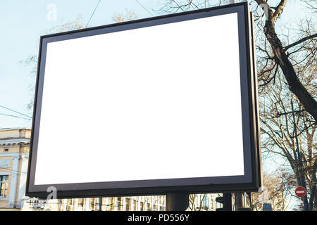 Rectangular empty billboard on street of old city with building and sky on background. View from pedestrian on blank banner street advertising of larg Stock Photo
