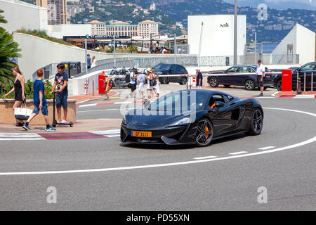 Black McLaren 570S diving on the Circuit de Monaco and the entrance of the Fairmont Hairpin street circuit of Monte Carlo Stock Photo