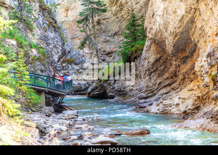 BANFF, CANADA - JUL 30, 2018: Visitors sightseeing at Johnston Canyon of Banff National Park, a popular hiking trail through the walkway on the limest Stock Photo