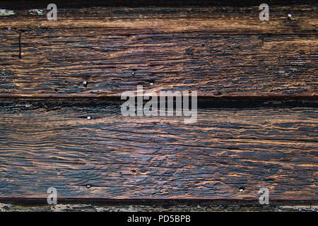 Weathered rustic wood plank background texture with yellow, black, and brown color tones Stock Photo